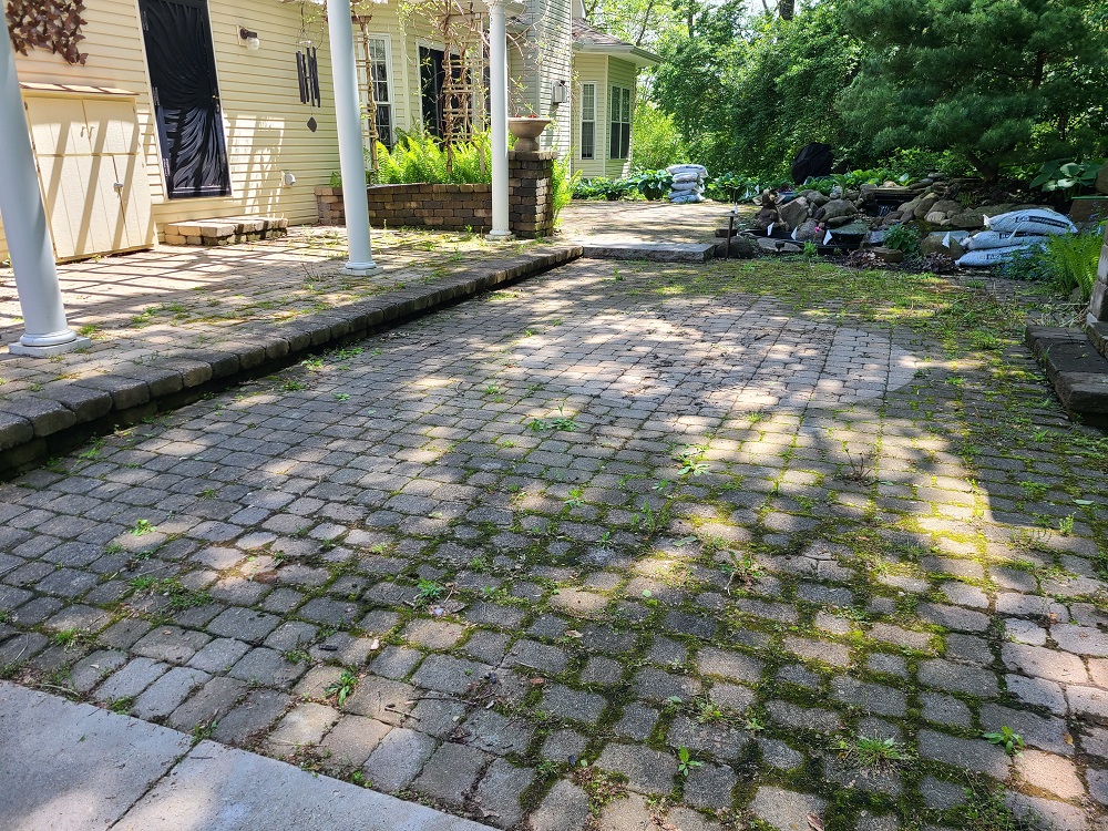 Before power washing paver patio Image